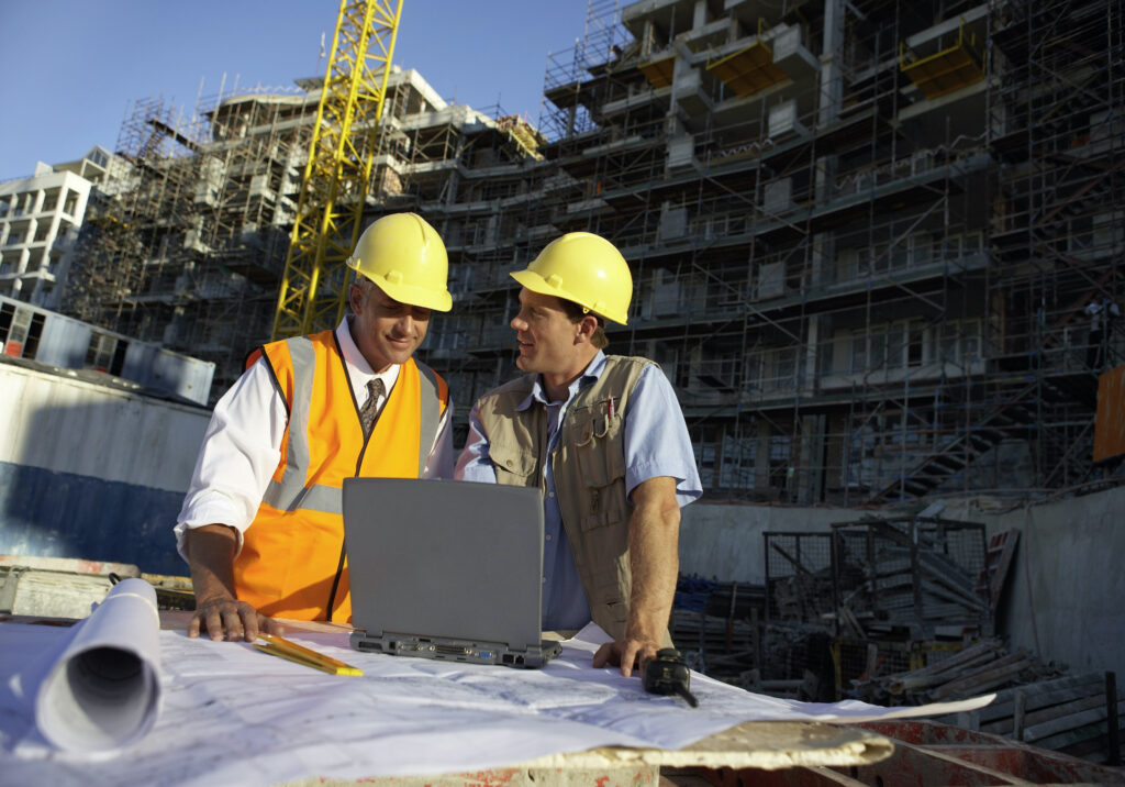 Contractor reviewing house plans and cost breakdown as part of residential estimating services for a new home construction project